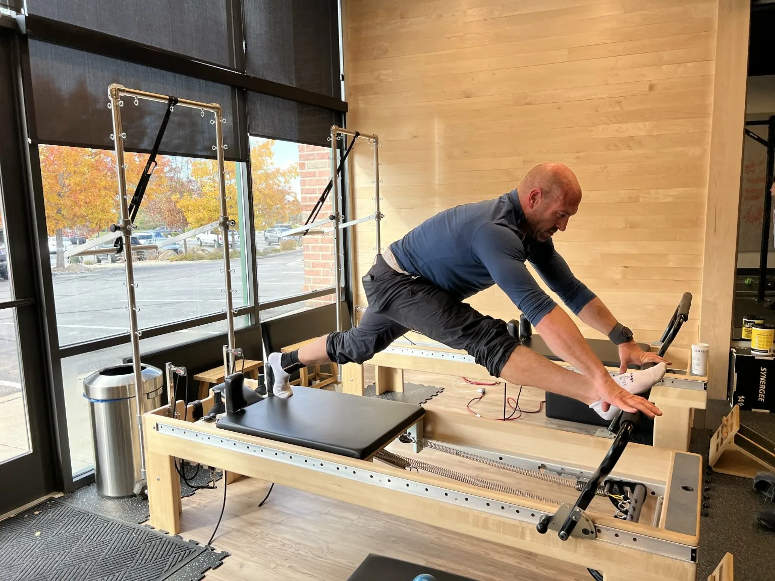 Joe working on movement on a Pilates reformer in the studio