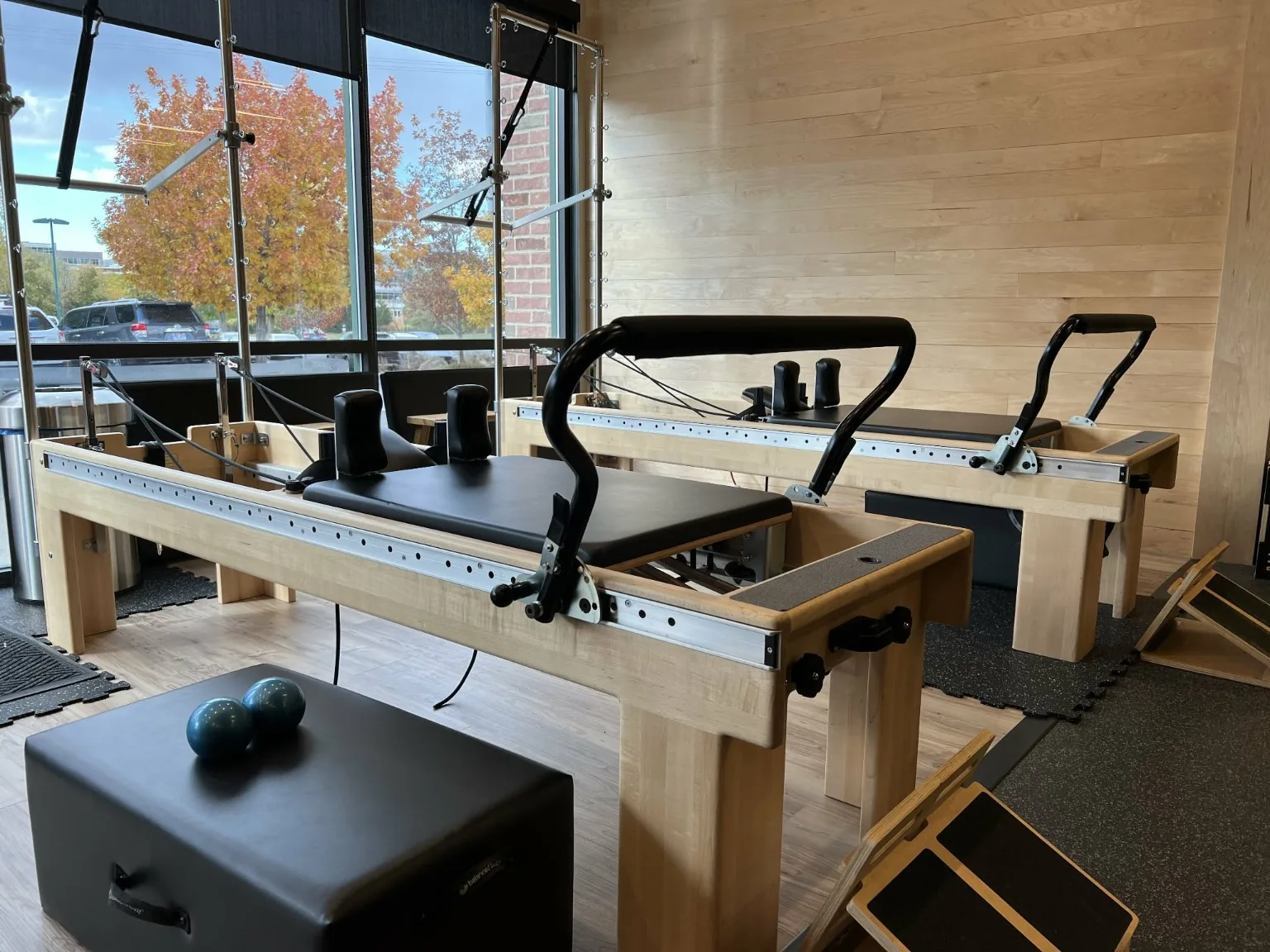 Pilates reformers beside the windows at the Specialized Fitness studio